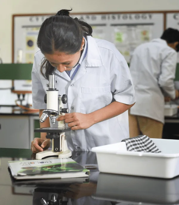 Student using a microscope in the science laboratory at Nalanda ICSE School Vadodara